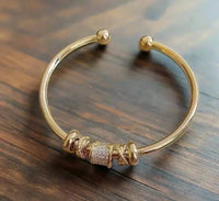 Adjustable bracelet with golden charms