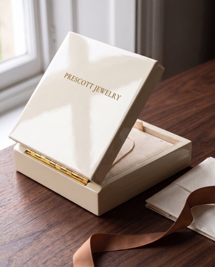 A Prescott Jewelry gift box on a walnut table